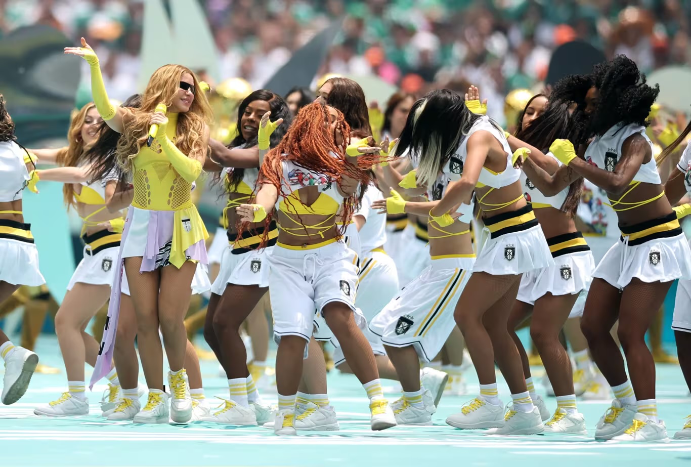 Performers in gold and white during the opening ceremony show